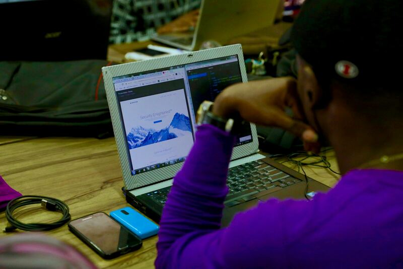 A designer reviewing a web layout on a laptop