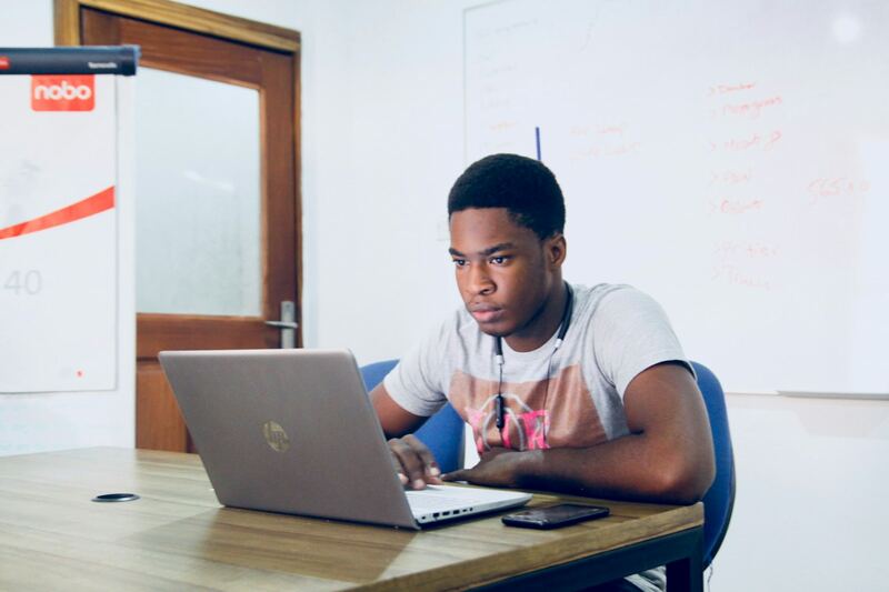 A developer thinking through a problem at his laptop